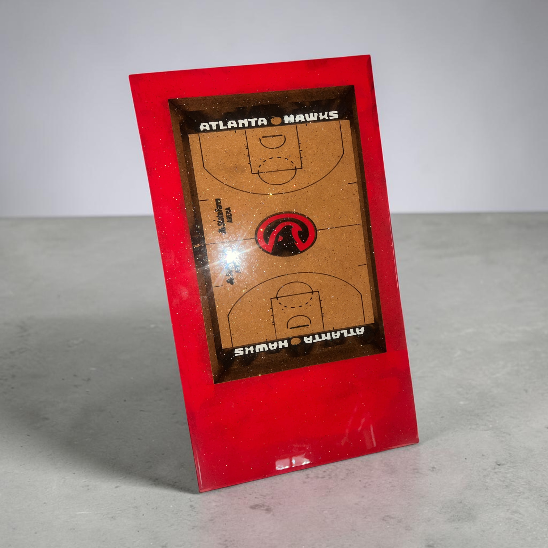 Custom hand cut, painted, laser engraved, and epoxy Atlanta Hawks basketball court wall art on wood